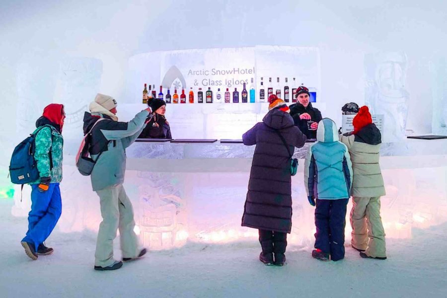 Tourists enjoying drinks at the Ice Bar in Arctic Snow Hotel and Igloos, Rovaniemi