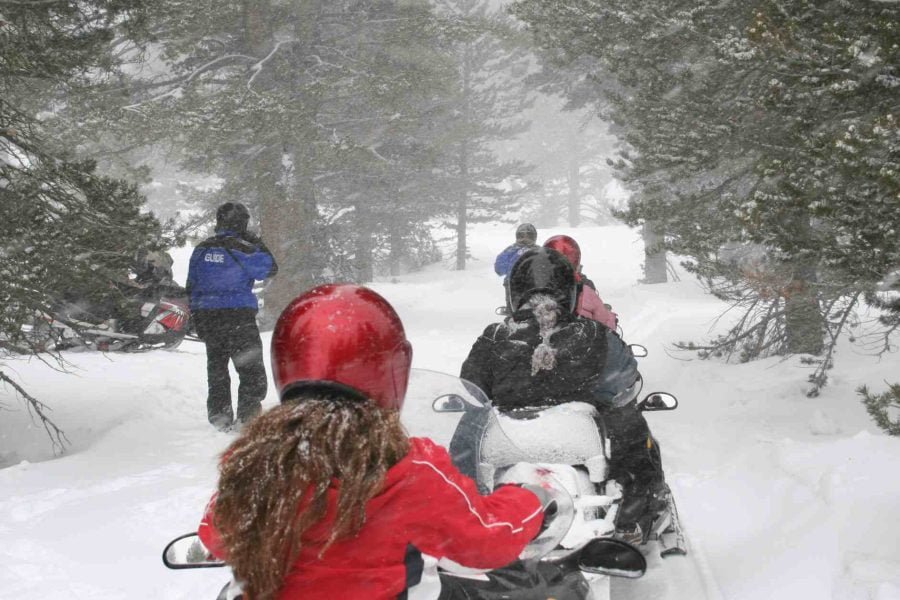 Group of tourists enjoying a snowmobile safari in Rovaniemi during the winter season.