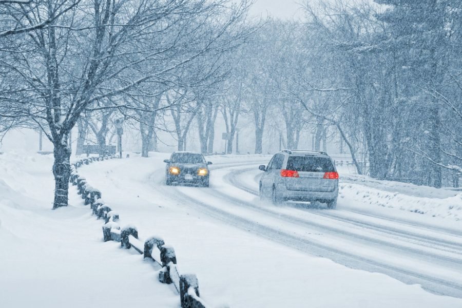 Cars driving from Kiruna to Rovaniemi on a snow-covered road in winter.