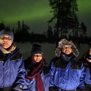 Ms. Shivani and her family witnessing the Northern Lights during their Finland tour with finlandtour.fi
