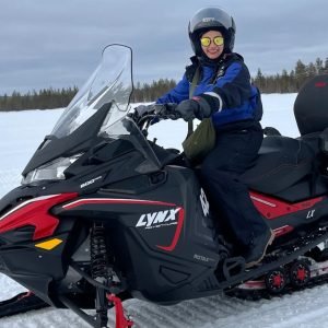 Ms. Yen enjoying a snowmobile safari during her solo Finland Northern Lights tour with finlandtour.fi