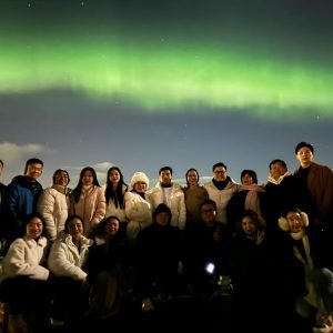A group of travelers on a Northern Lights tour in Tromsø during the 17 Days Iceland, Norway and Finland Tour Itinerary.