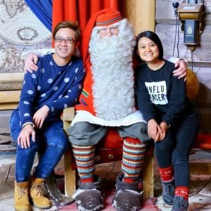 Couple traveler posing at Santa Claus Village in Finland during a winter tour