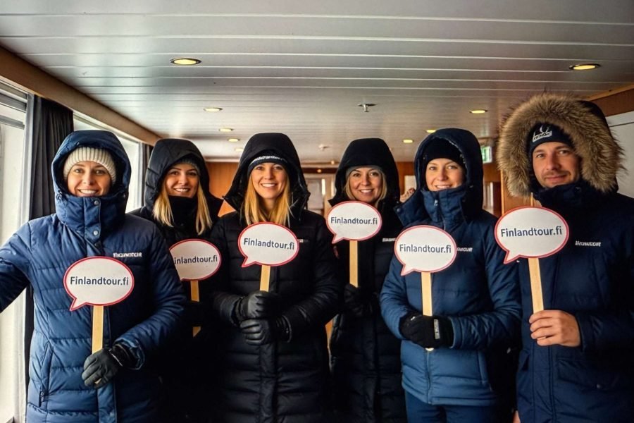 Travelers relaxing inside their Havila cruise cabin en route to Tromsø during the 9 days Rovaniemi, Levi, Kirkenes & Tromso tour
