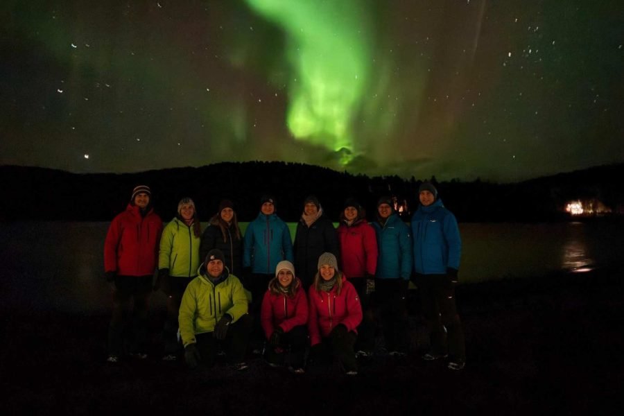 Travelers in Ivalo enjoying Northern Lights during Helsinki, Tromsø – Svolvær by Hurtigruten Cruise, Narvik, Kiruna, Rovaniemi and Ivalo tour.