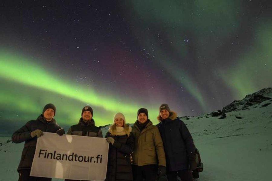 Travelers watching the Northern Lights during 12D Saariselkä, Rovaniemi, Kiruna, Narvik, Svolvær, Tromsø & Oslo tour